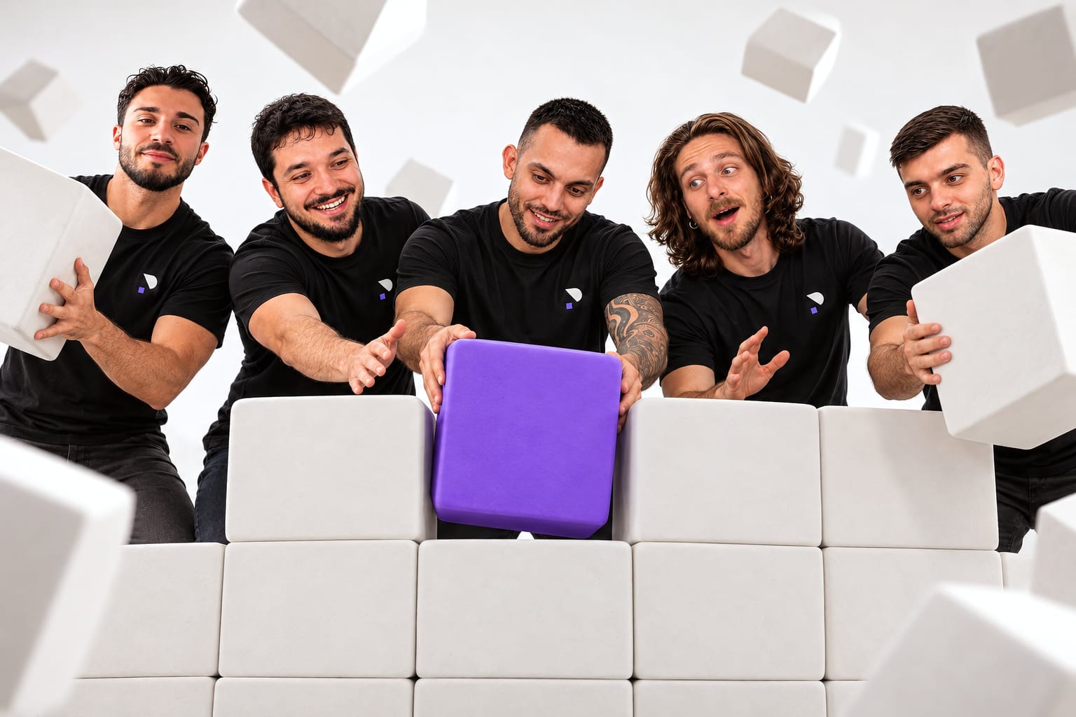 The PixelVision team slotting a purple block into a white wall